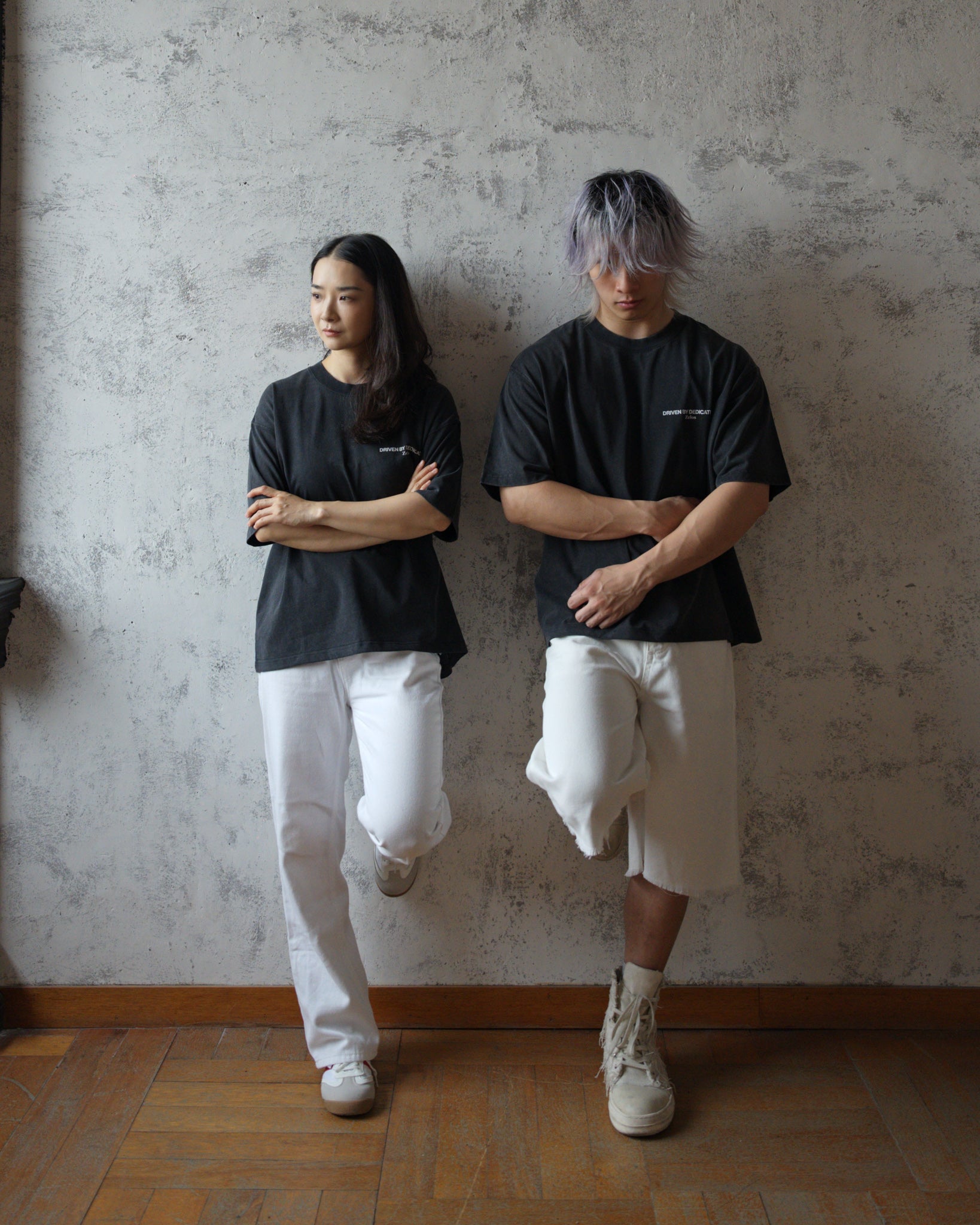Two models wearing Zelos Tee Black in sizes S and L, front view